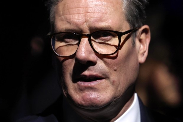 a close up of a man wearing glasses and a suit