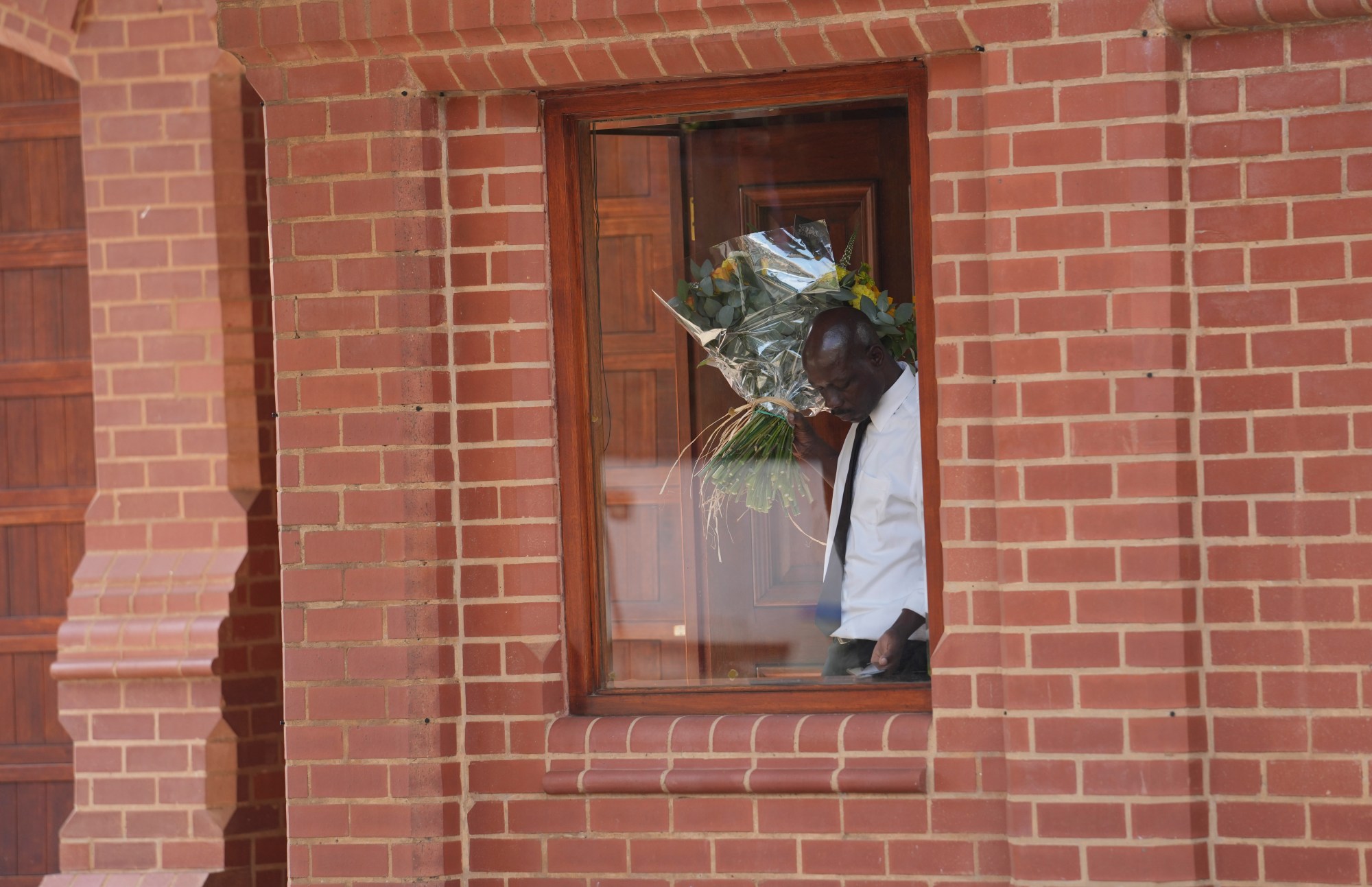 Flowers are delivered to the home of Oscar Pistorius' uncle in the upmarket suburb of Waterkloof, Pretoria, South Africa, Friday, Jan. 5, 2024. South African athlete Pistorius has been released from prison on parole after serving nearly nine years in prison for killing his girlfriend Reeva Steenkamp on Valentine's Day in 2013 .(AP Photo/Tsvangirayi Mukwazhi)