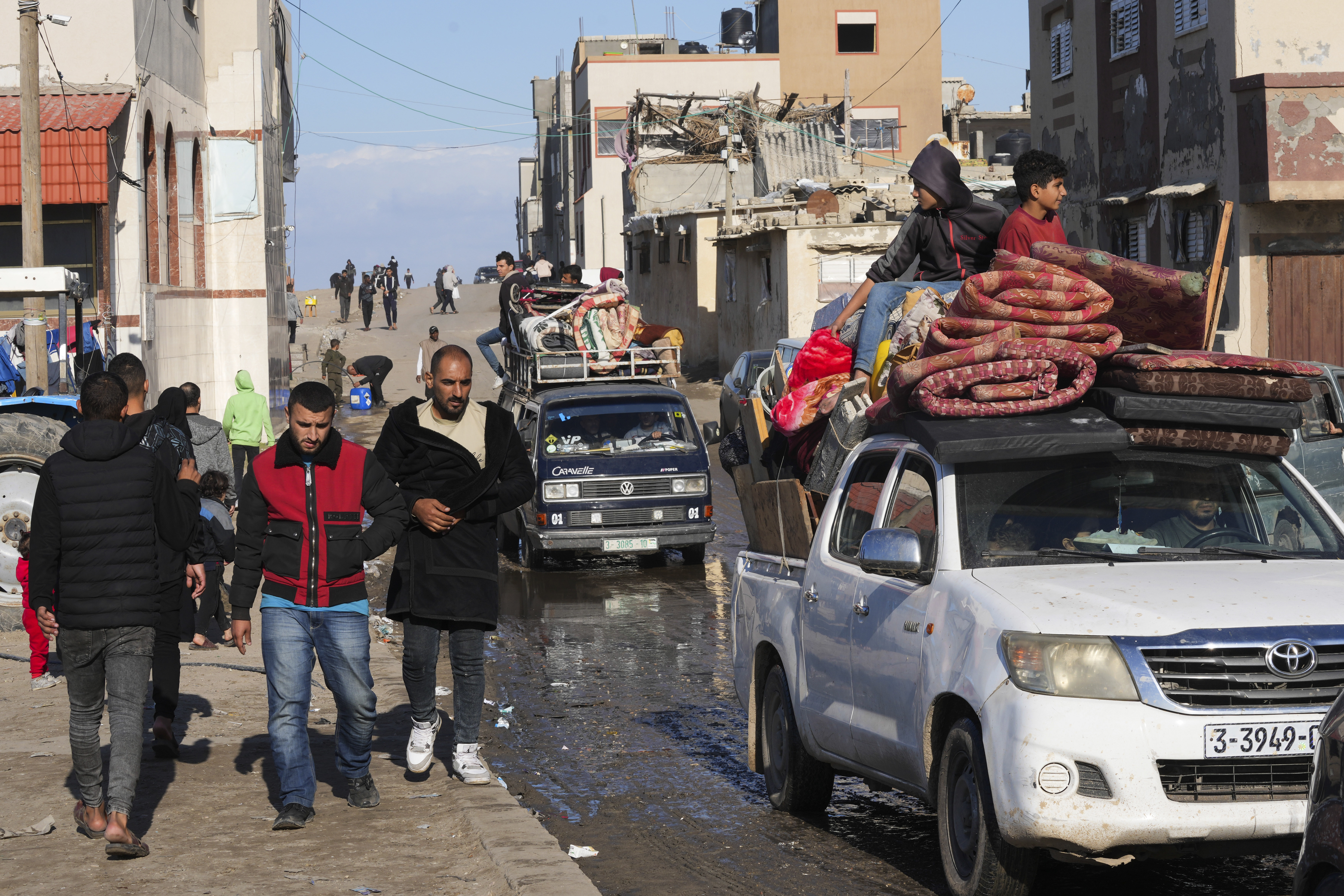 Palestinians flee the Israeli ground offensive in the central Gaza Strip, heading south through Deir al BalahFriday, Jan. 5, 2024. (AP Photo/Adel Hana)