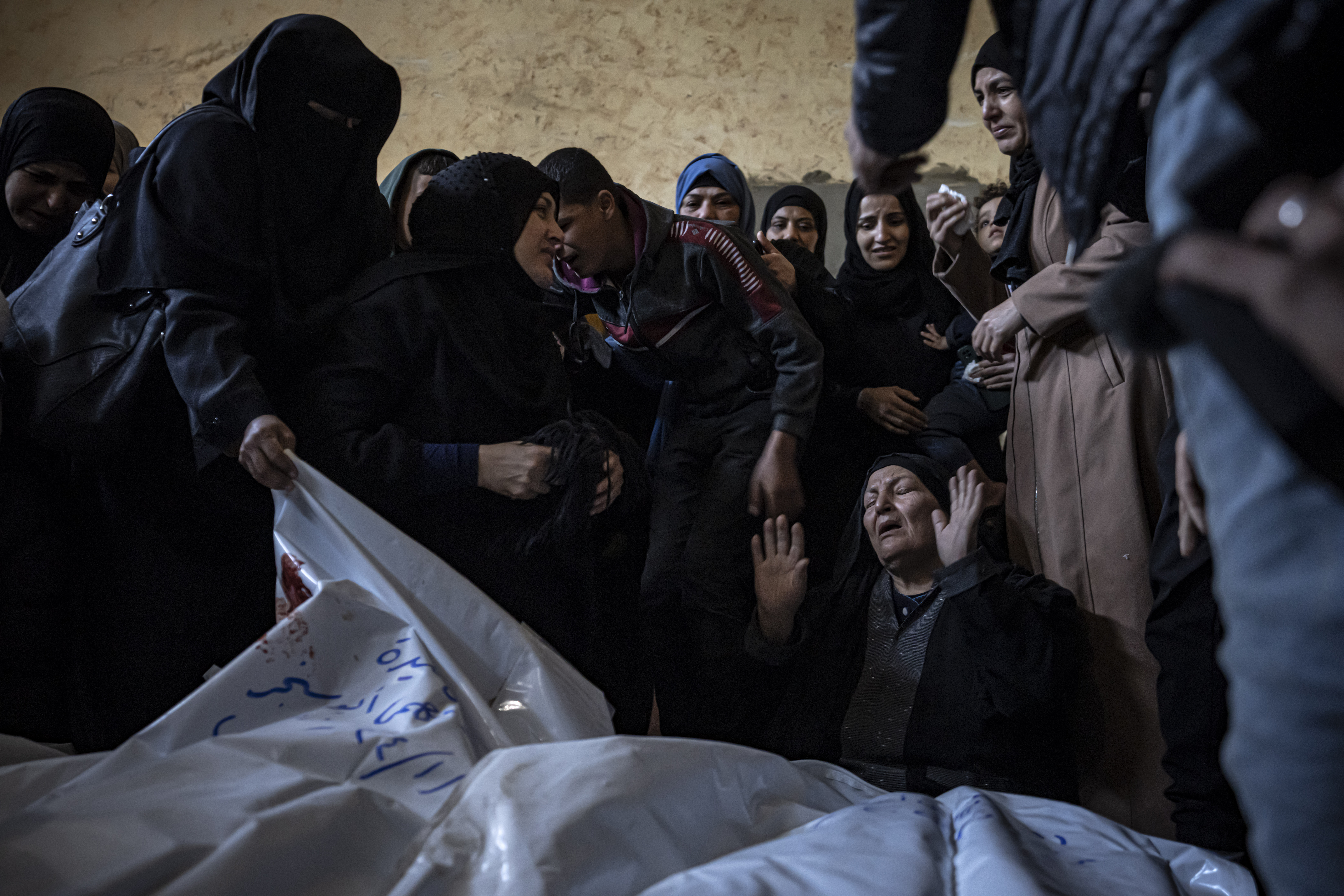 Members of the Abu Sinjar family mourn their relatives killed in the Israeli bombardment of the Gaza Strip, at their house in Rafah, southern Gaza, Friday, Jan. 5, 2024. (AP Photo/Fatima Shbair)