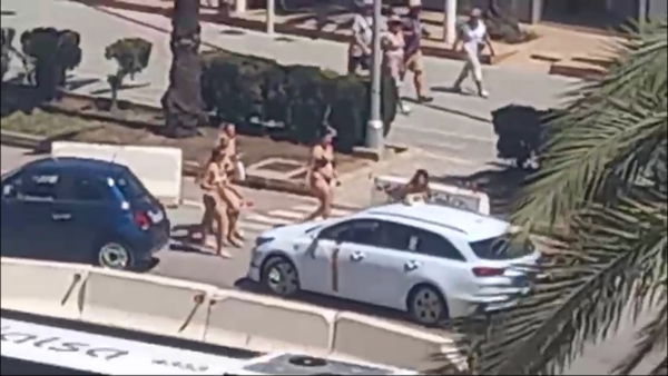 Moment near-NAKED tourists in bikinis are confronted by furious Majorca locals